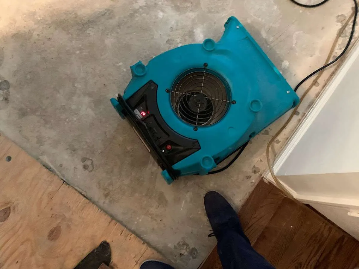 Air mover drying subfloor during Commercial Water Damage Restoration in Charles Town
